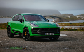 Green 2021 Porsche Macan GTS Sport Package car against the background of the bridge