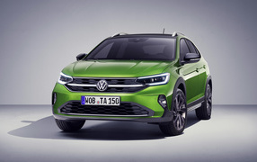 Green stylish 2021 Volkswagen Taigo on gray background