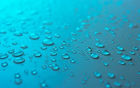 Blue background with water drops on the surface