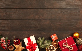 Many gifts with toys on a wooden background