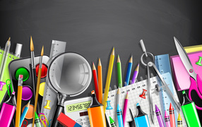 Разноцветные канцелярские предметы на сером фоне