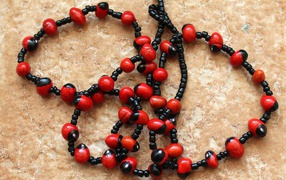 Red and black beads in beads on the table