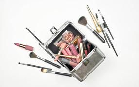 Set of cosmetics in a suitcase on a white background