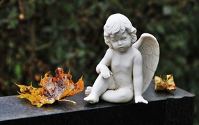 Статуэтка белого ангела с желтыми листьями