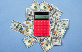 Lots of dollars with calculator on blue background