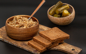 Buckwheat on the table with bread and cucumbers