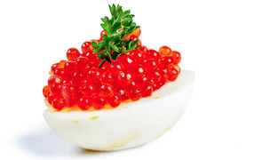 Egg stuffed with red caviar on a white background