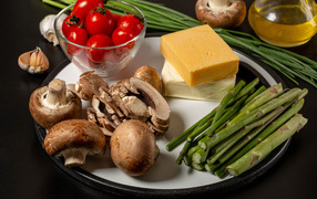 Plate with mushrooms, cheese, tomatoes and asparagus