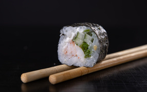 Sushi with rice and cucumbers on the table