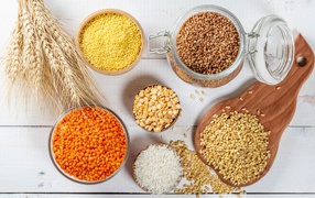 Разные крупы на столе с колосьями 