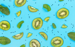 Kiwi slices with mint on a blue background