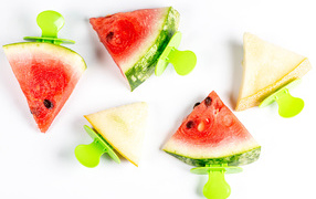 Pieces of watermelon and melon on a stick on a white background