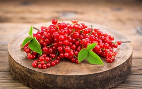 Спелая красная смородина на деревянной доске