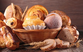 Fresh appetizing pastries in a basket on the table