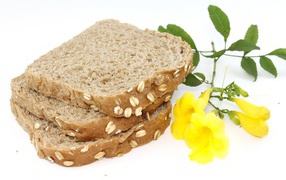 Pieces of fresh appetizing bread with yellow flowers