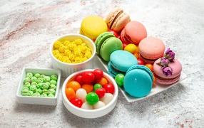 Печенье макарун с конфетами на сером столе