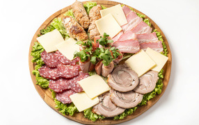 Meat products with cheese on a blackboard on a white background