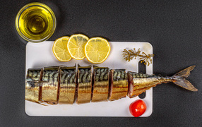 Appetizing mackerel on a board with lemon and butter