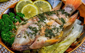 Baked carp with lemon and lettuce
