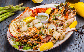 Baked seafood on a plate with lemon