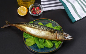 Large smoked mackerel on a plate with basil