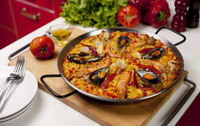 Pilaf with seafood on a table with vegetables
