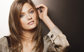 Красивая голубоглазая девушка в рубашке на коричневом фоне 