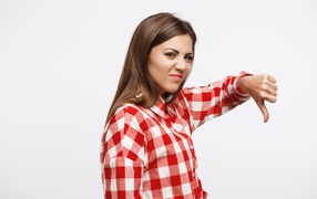 Недовольная девушка опустила палец вниз 