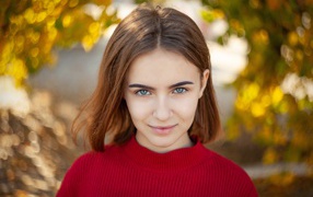 Девушка в красном свитере с короткой стрижкой 