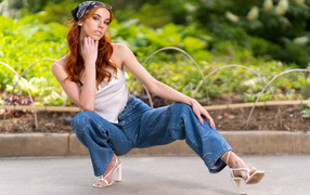 Рыжеволосая девушка в синих джинсах 
