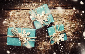 Three blue gifts on a wooden table