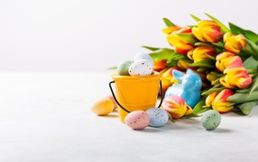 Букет тюльпанов на белом фоне с крашеными яйцами на Пасху