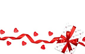 Gift with red ribbon and candles on a white background for Valentine's Day