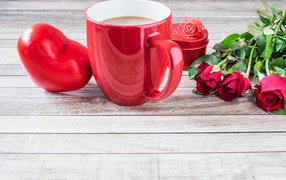 Mug on the table with a heart and a bouquet of roses for Valentine's Day