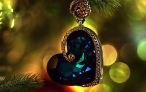 Blue gem in gold heart shaped jewelry