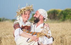 Loving couple on the field with wheat