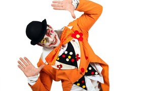 Male clown in a yellow suit on a white background