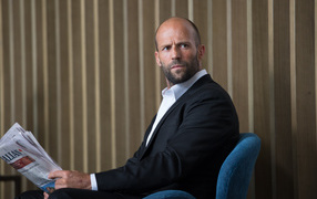 Actor Jason Statham in a chair against the wall