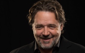 Smiling Russell Crowe on black background
