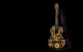 Красивая гитара с рисунком на черном фоне