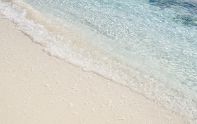 Clear water on white sea sand