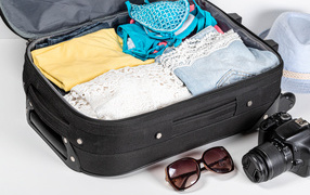 Vacation suitcase with camera and glasses