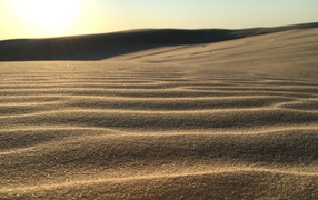 Golden sand in the desert by waves