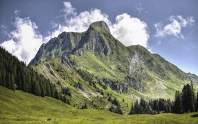 Большая зеленая гора под голубым небом