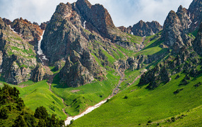 Large stone mountains with green grass carpet