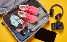 Traveler suitcase on yellow background
