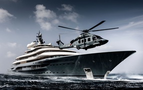 The helicopter lands on the yacht at sea