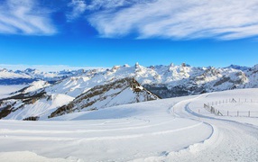 Beautiful white winter mountain landscape under blue sky