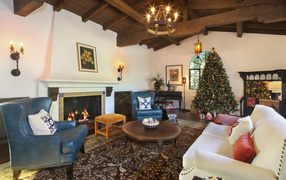 Красивая комната с камином украшена к Рождеству 