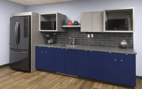 Blue cabinets and a large refrigerator in the kitchen
